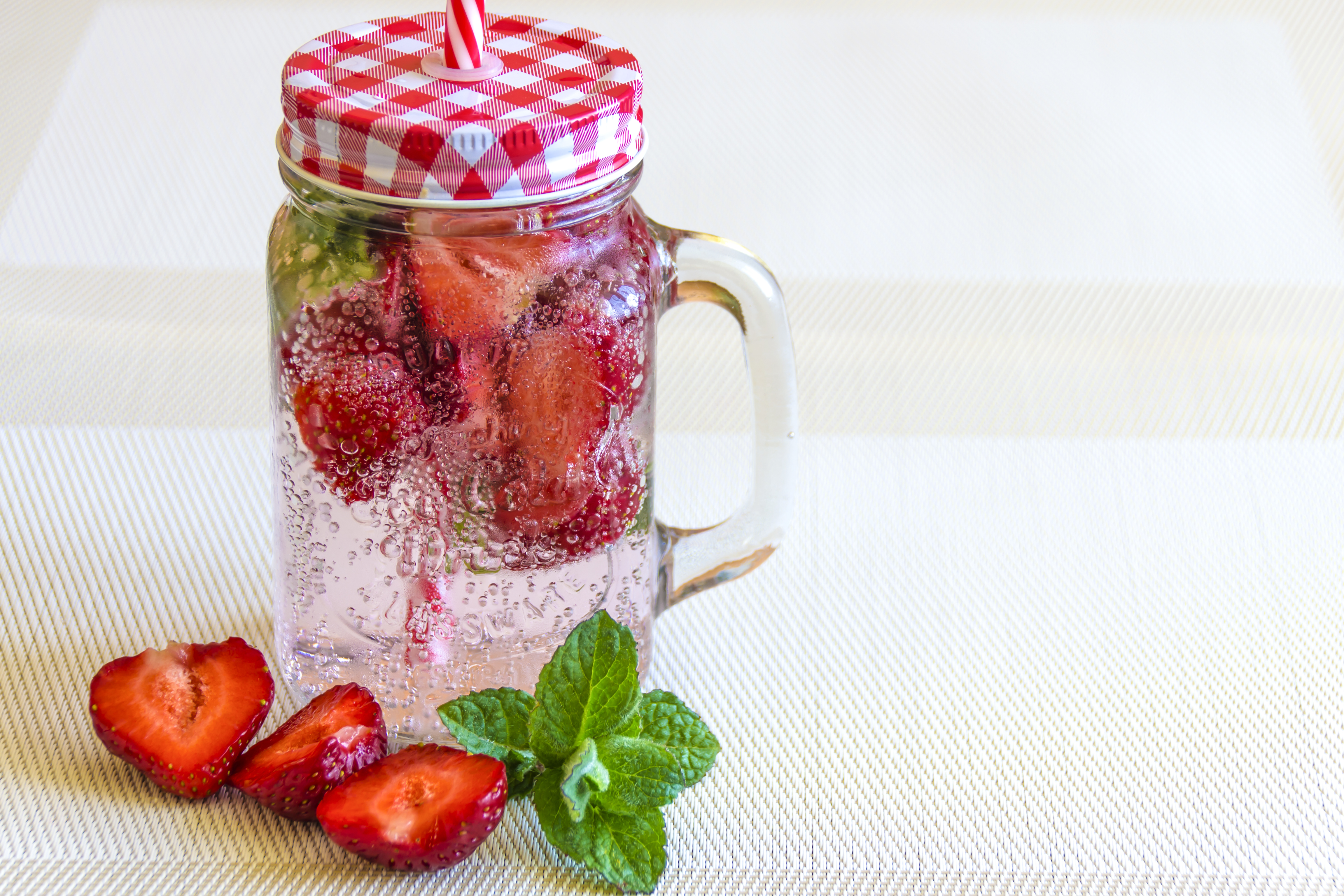 Though there are many ways to drink tasty water. Strawberry mint water is one of my favorites. Here is a jar with strawberry, water and mint.