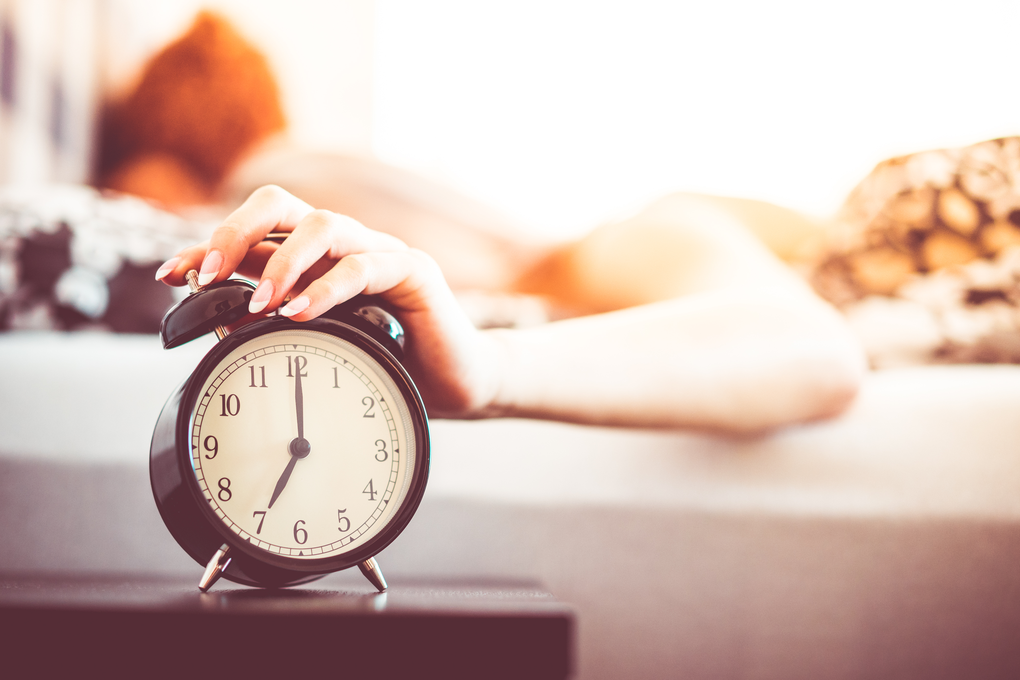 Looking for reason why you aren't losing weight. It might be because you aren't sleeping well. Here is alarm clock and a lady sleeping.