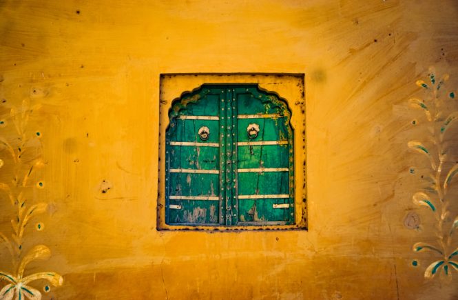 YOu should visit Jaipur at least once in your lifetime. Here is a yellow wall and green window in the town of Amer.