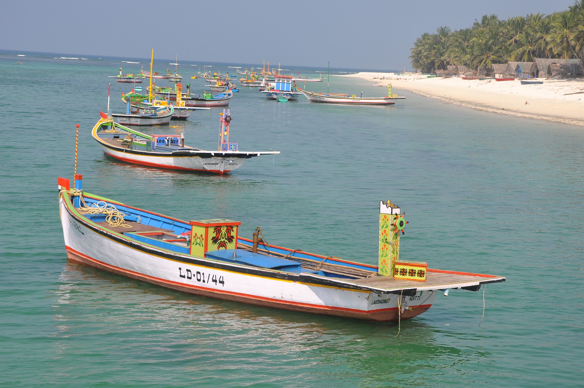 If you want visit any island in March in India, Lakshwadeep is a good option to visit. Here is a beach in Lakshwadeep with boats. Clear water and sand.